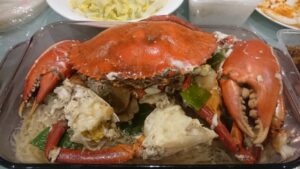 Mudcrab with ginger and spring onion on a bed of glass noodles